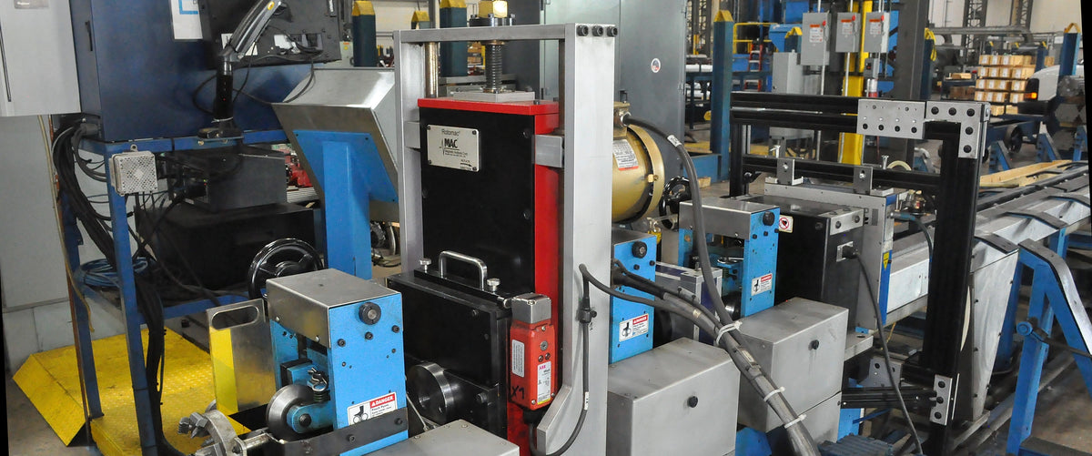 An eddy current rotary probe, on an eddy current test system with entry and exit conveyors. 